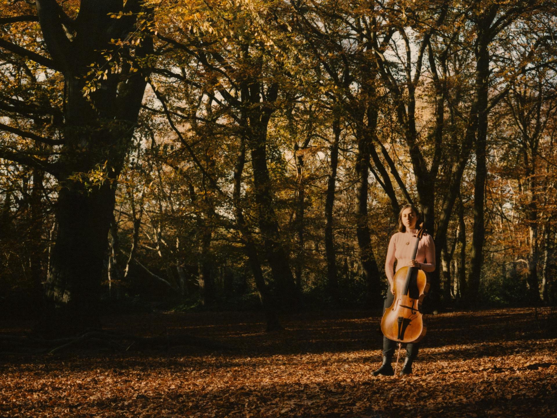 Ffern Artist Georgina Lloyd Owen Autumn 21 with cello in the woods.jpg